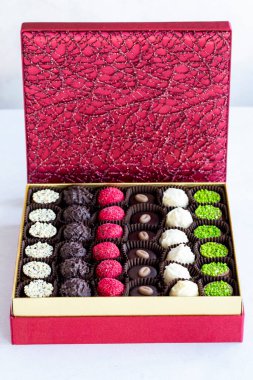 Packed chocolate. Assortment of packed truffle chocolates on a white background. close up