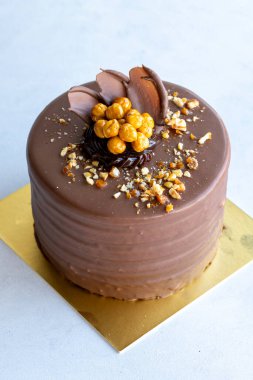 Croquant cake. Celebration cake with liquid chocolate, cream and croquant on a white background. close up