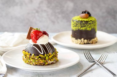 Pistachio and chocolate cake on gray background. close up