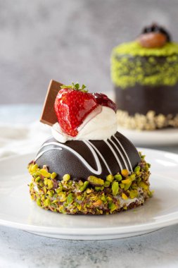 Pistachio and chocolate cake on gray background. close up