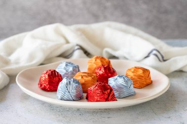 Special chocolate or gilded chocolate. Chocolates covered on gray background. Local name yaldizli cikolata. close up