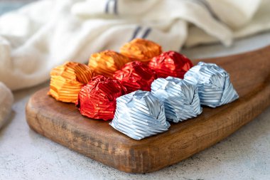 Special chocolate or gilded chocolate. Chocolates covered on gray background. Local name yaldizli cikolata. close up