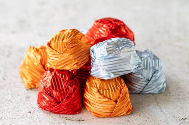 Special chocolate or gilded chocolate. Chocolates covered on gray background. Local name yaldizli cikolata. close up