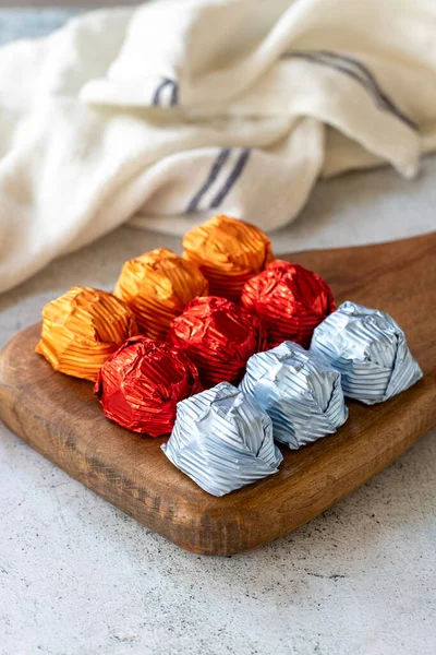 Special chocolate or gilded chocolate. Chocolates covered on gray background. Local name yaldizli cikolata. close up