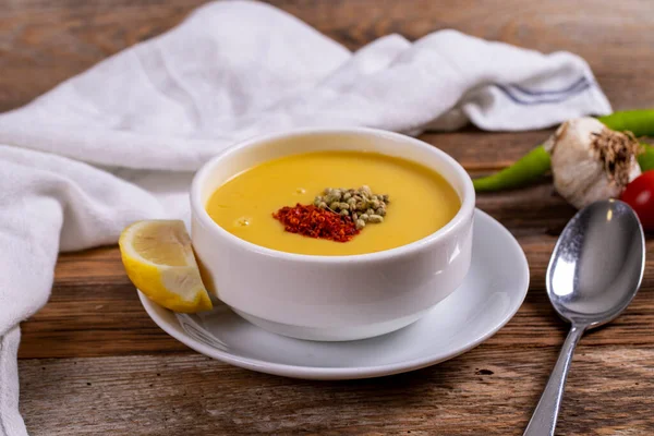 Lentil soup. Strained lentil soup on wooden background. Traditional Turkish cuisine. Close-up. local name suzme mercimek corbasi