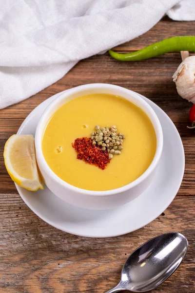 Lentil soup. Strained lentil soup on wooden background. Traditional Turkish cuisine. Close-up. local name suzme mercimek corbasi