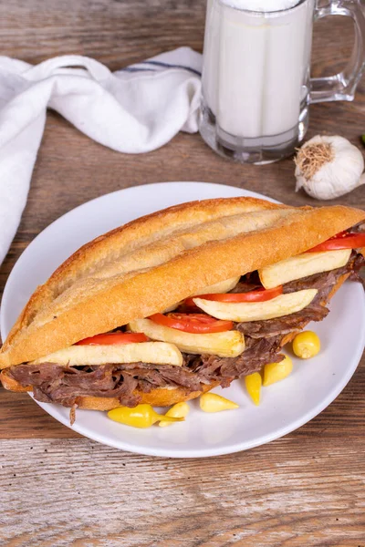 Doner kebab between bread. Meat doner kebab on wooden background. Traditional Turkish cuisine. close up