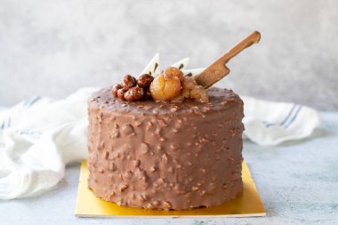 Chocolate and chestnut celebration cake. Birthday cake on gray background. close up