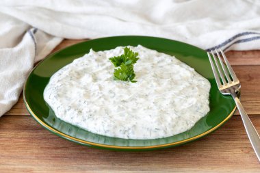 Dry tzatziki on wood floor. Snack prepared with yogurt and mint. Traditional Mediterranean cuisine delicacies. Local name kuru cacik or tzatziki. close up