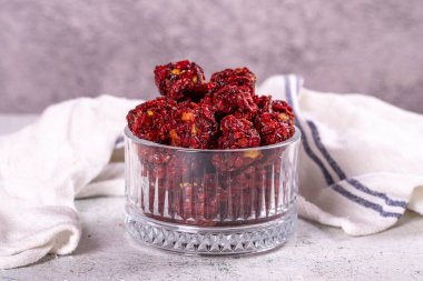 Sour red Persian barberry and pistachio Turkish delight. Sour Turkish delight on a gray background. Traditional Turkish delicacies. close up