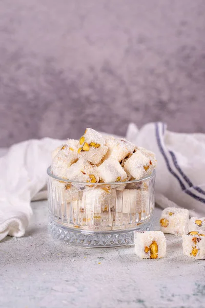 Turkish Delight with Coconut and Pistachio. Sweet Turkish delight on gray background. Traditional Turkish delicacies. close up