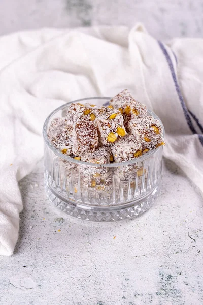 Turkish Delight with Coconut and Pistachio. Sweet Turkish delight on gray background. Traditional Turkish delicacies. close up