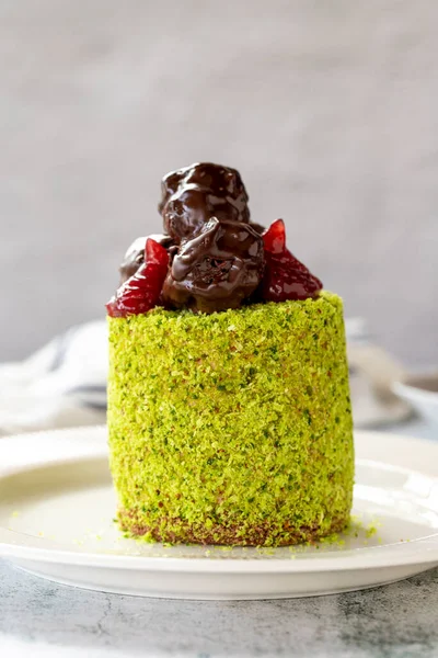 Fıstıklı ve meyveli kek. Gri arka planda kek. Kapat.