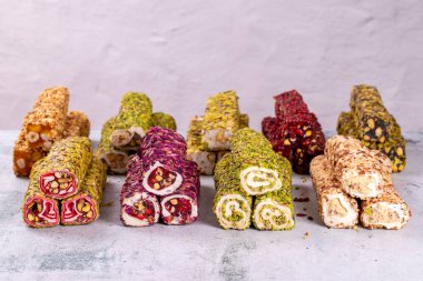 Gri arka planda fıstıklı Türk lokumu çeşitleri. Karışık Türk Lokumu. Yakın plan. yerel adı Fistikli fitil lokum