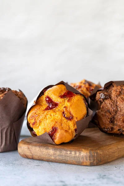 Muffins cake. Bakery products. Chocolate and fruit cake on gray background. close up