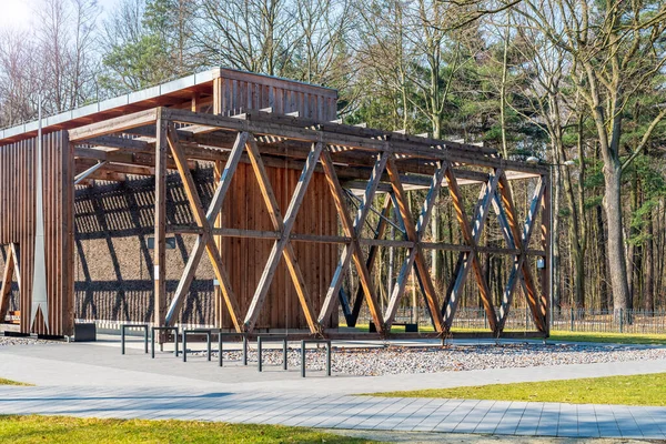 A graduation tower in a city park surrounded by greenery, a place for inhalation and recreation, a structure made of wood and blackthorn. Early spring