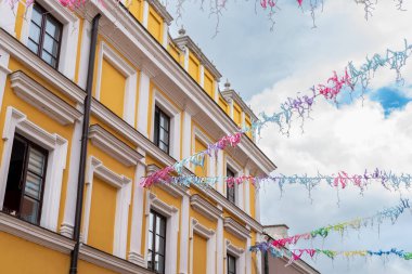 A colorful garland against the background of a beautiful historic, renaissance tenement house. Zamosc, Poland