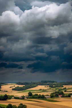 Storm clouds over hills and farmland. Roztocze, Poland