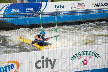 Krakow, Poland - August 27th, 2022: Canoeist struggling with the power of rushing current in whitewater canoening track in Krakow. Extreme sport and adrenaline as great way to spend free time.