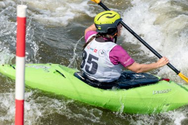 Krakow, Poland - August 27th, 2022: Canoeist struggling with the power of rushing current in whitewater canoening track in Krakow. Extreme sport and adrenaline as great way to spend free time.