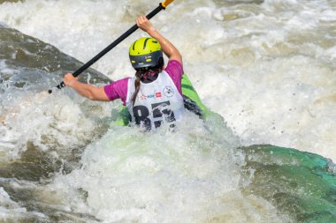 Krakow, Poland - August 27th, 2022: Canoeist struggling with the power of rushing current in whitewater canoening track in Krakow. Extreme sport and adrenaline as great way to spend free time.