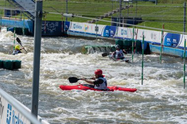 Krakow, Poland - August 27th, 2022: Canoeist struggling with the power of rushing current in whitewater canoening track in Krakow. Extreme sport and adrenaline as great way to spend free time.