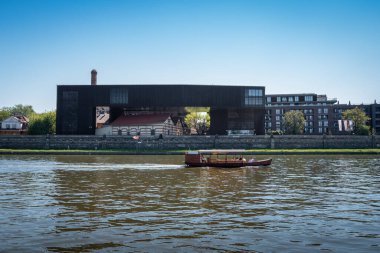 Krakow, Poland - August 27, 2022 - Boulevards on the Vistula River. Water tram on the river. Center for Documentation of the Art of Tadeusz Kantor Cricoteka