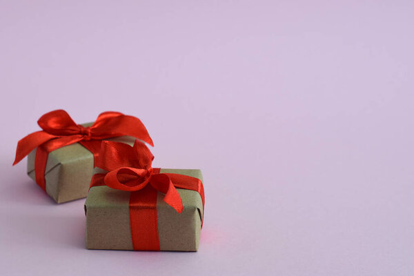 Gifts in craft paper tied with a red ribbon