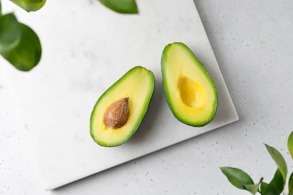 Flat Lay Composition Cut Avocados White Marble Board Green Leaves — Stock Photo, Image