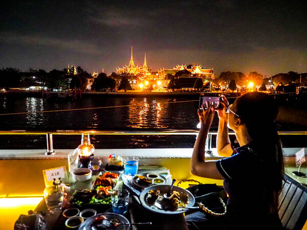 BANGKOK, THAILAND - DEC, 2021 :The luxury dinner cruises over Chao Phraya river, restaurant cruise in Bangkok.