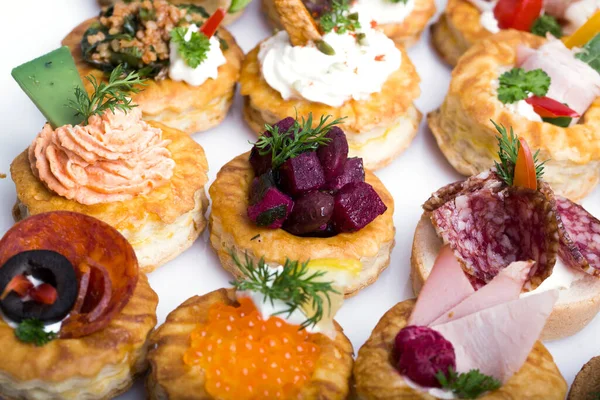 Füme somon, salatalık, vişneli domates ve mozarella ile servis edilen farklı kanepeler.