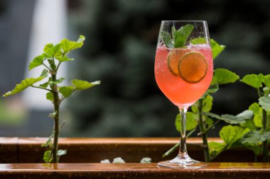 Alcohol cocktail on a wooden barrel