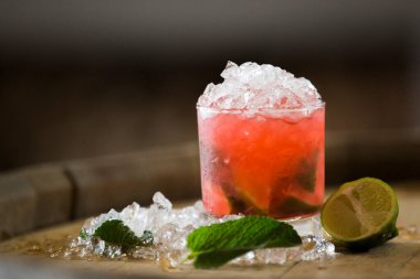 a glass of mojito drink with lime and ice, selective focus