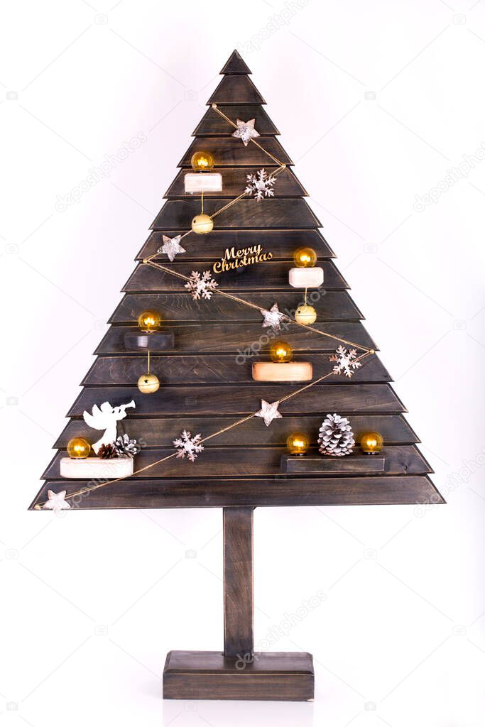 Decorative Christmas tree made of wood isolated on a white background