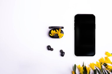 phone on a white background and wireless headphones