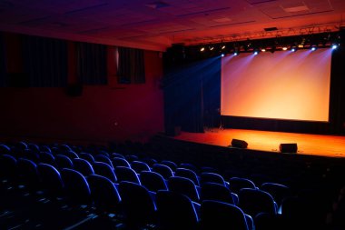 movie theater with blue seats and blank screen