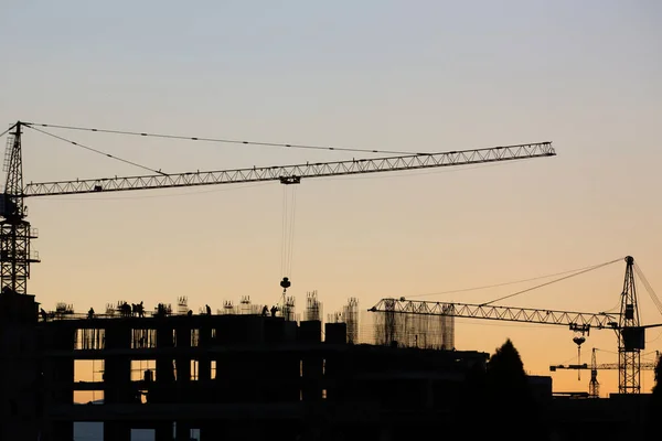 Silhouette of Survey Engineer and construction team working at site over blurred industry background