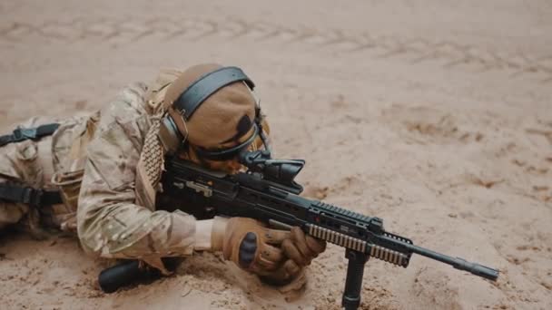 Marine soldier reaching out for a handgun pistol at ground level stance aiming using target scoop — Stock Video