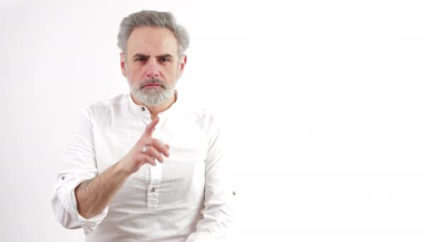 White caucasian man silencing someone or trying to say he wil keep a secret, medium shot, white background — Stock Video