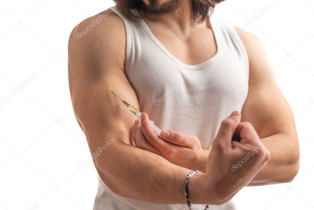 Doping concept. Young caucasian man in a tank top cheating by using doping injections. Isolated over white background.