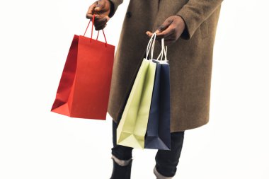 colorful shopping bags black-skinned man white background - close-up shot