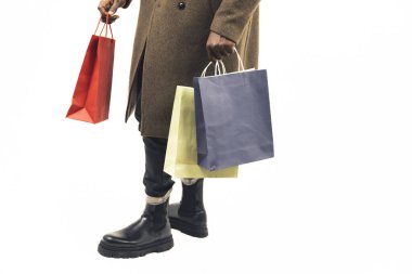 Man with shopping bags focus on the bags white background - close-up shot