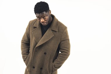 Afroamerikalı elleri ceplerinde kameraya bakıyor beyaz arka plan - orta ekran