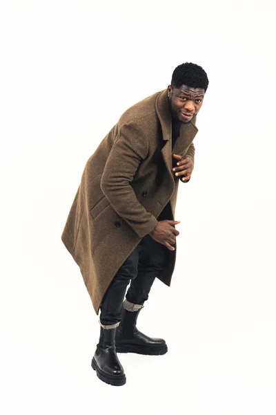 Person of color showing coat to model standing white background - full shot —  Fotos de Stock