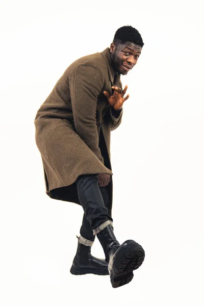 Black male model pointing shoe at the camera white background - full shot —  Fotos de Stock