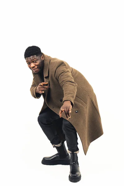 African american having fun modeling pointing at the camera white background - full shot —  Fotos de Stock