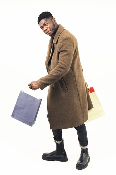Afroamerican man doing shopping white background - full shot —  Fotos de Stock