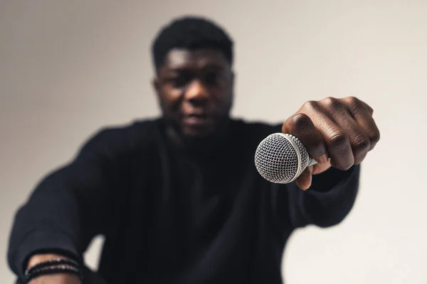 Person of color holding exhibiting microphone studio - close up shot — Fotografia de Stock