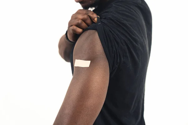 Vaccinated black skin man arm white background - close up shot — Stockfoto