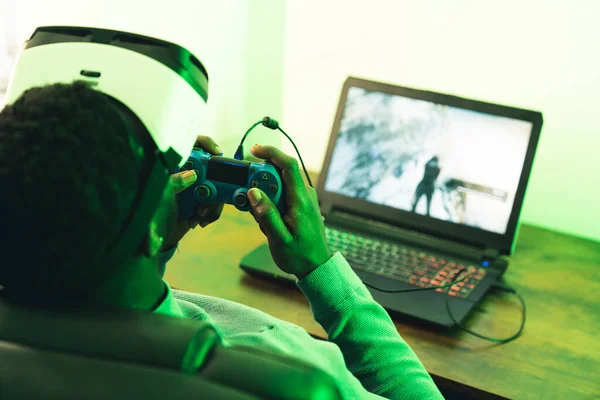 Afroamerikaanse man speelt VR headset game pad joystick - over schouder schot — Stockfoto